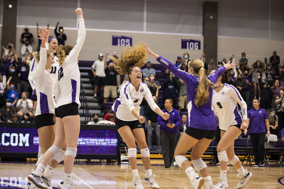 Womens volleyball team celebrating a win