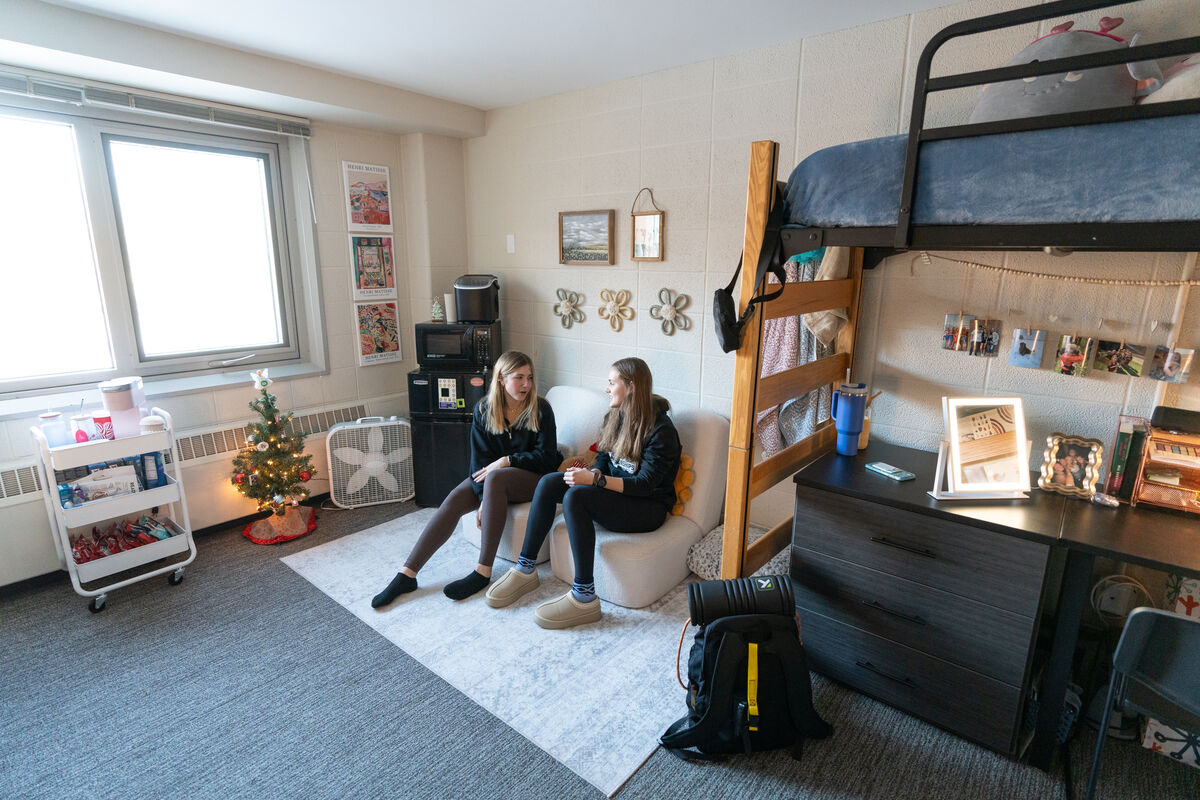 Students sitting and talking in dorm room