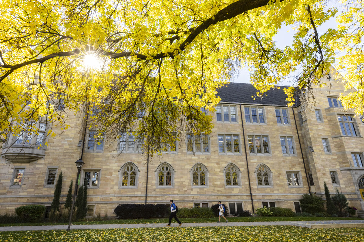 Aquinas Hall beneath yellow trees