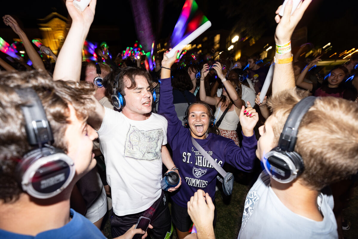 Students dancing in the dark with headphones on