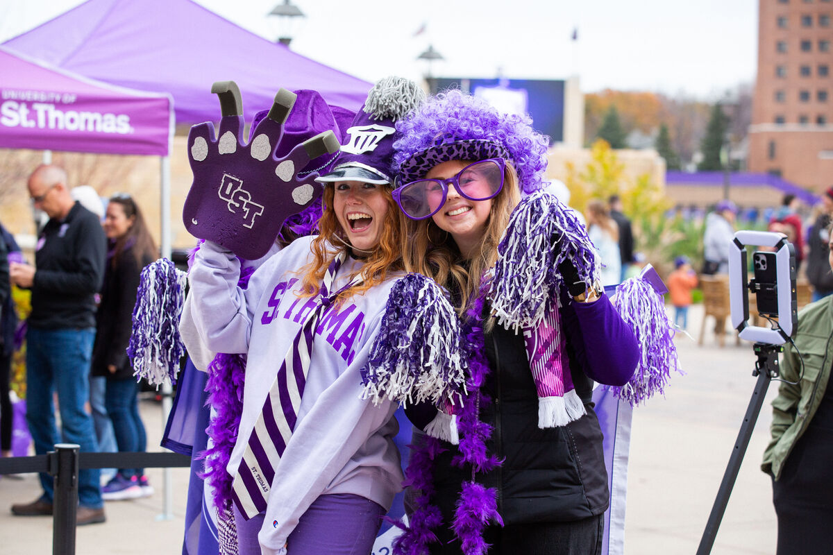 Students posing with purple props