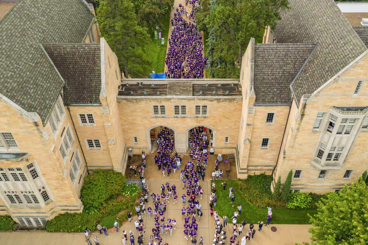 Aerial shot of students walking through the arches