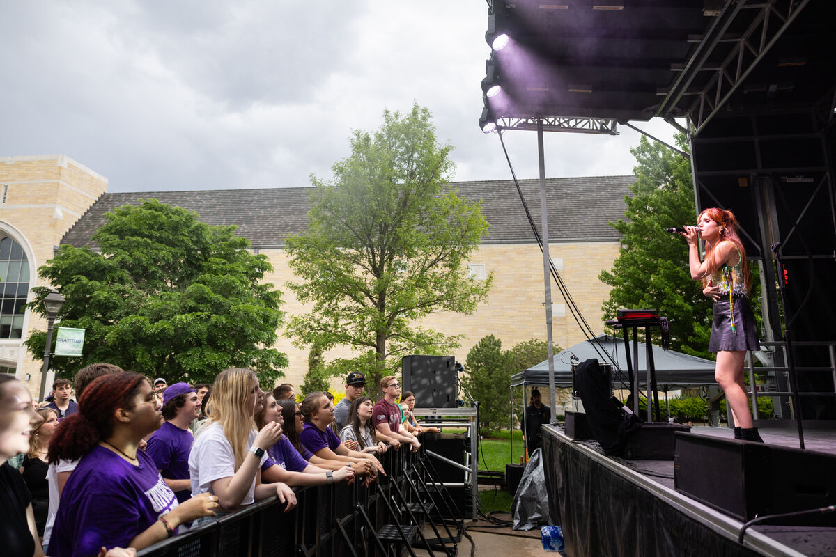 Singer on a stage performs for a crowd