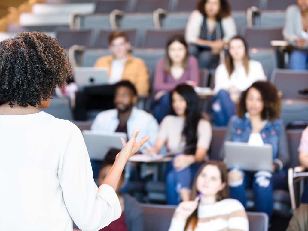 A speaker talks to a class.