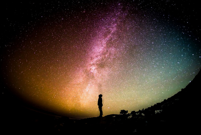 Man looks up to observe the cosmos.